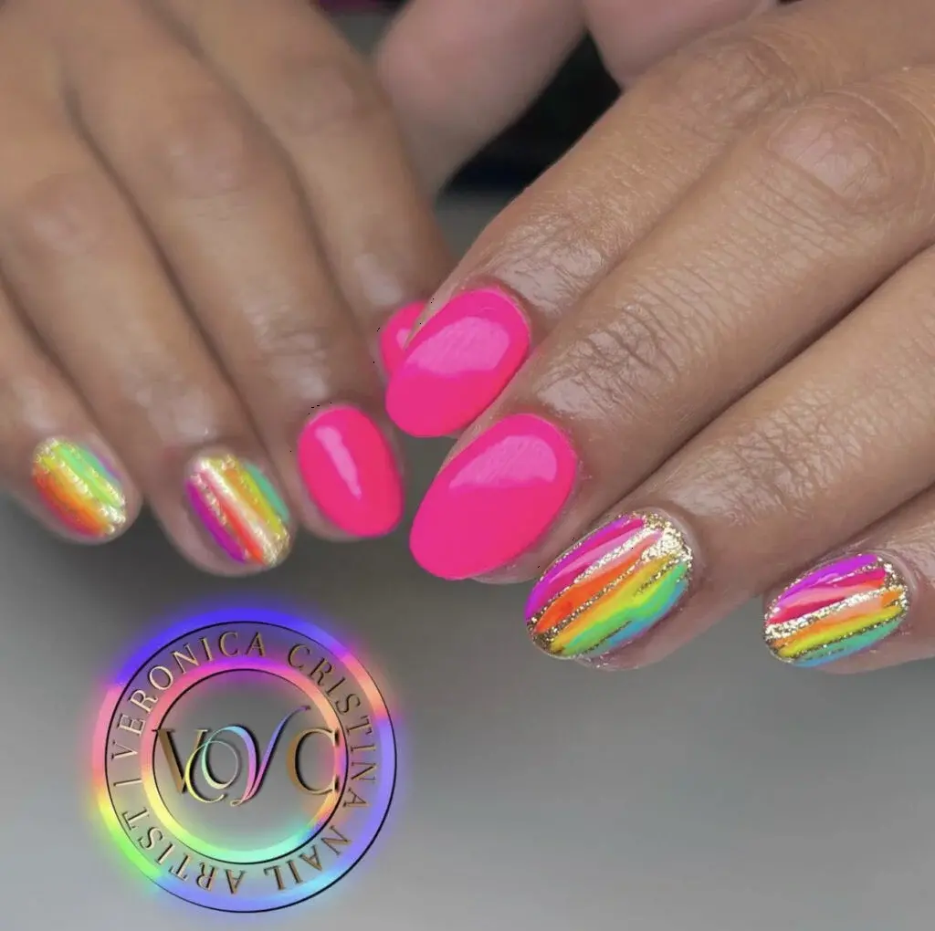 These vibrant pink nails feature neon rainbow stripes with a holographic finish on two accent nails. The design is modern and playful, ideal for making a statement at any summer event.