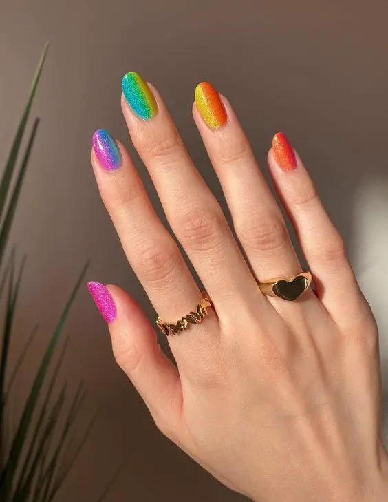 These rainbow nails combine various neon colors in a gradient style, enhanced with a glittery finish. Each nail transitions smoothly from one vibrant shade to another, perfect for creating a sparkling, eye-catching look at any party or event.