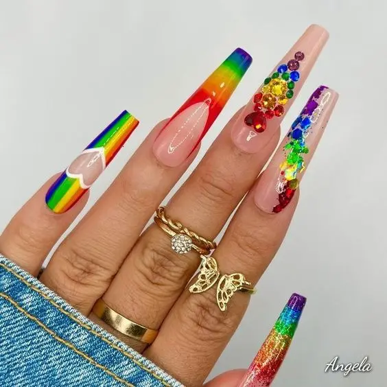 Spectacular long ballerina nails featuring intricate designs with neon stripes, glitter, and varied textures. Each nail is a masterpiece, combining elements like rainbows, gradients, and jewel embellishments to create a stunning visual impact that\'s full of personality and flair.