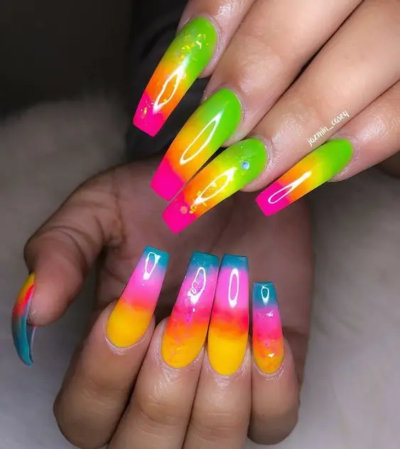 These ballerina-shaped nails present a beautiful gradient of neon colors blending seamlessly into each other. Accentuated with subtle water droplets effects and vibrant outlines, the design adds a fresh and dynamic edge to a classic style.