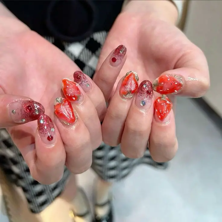 This innovative design features a mix of transparent and glittery red almond-shaped nails, adorned with three-dimensional strawberry art. The nails exude a playful yet glamorous feel, making them perfect for special occasions or everyday sparkle.