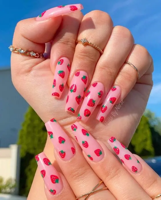 Bright and cheerful, this manicure showcases medium-length square nails with a vibrant pink base and evenly spaced strawberry designs. The fresh and simple style is ideal for a fun, casual look that adds a pop of color to any outfit.