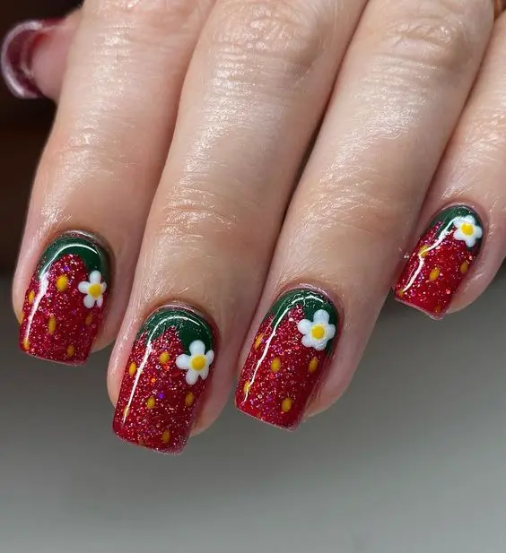 Featuring a rich, glittering red base with white daisy accents, this strawberry design embodies a vibrant, festive look. The smooth, round edges of the nails provide a classic, polished appearance, perfect for seasonal celebrations or as a bold everyday statement.