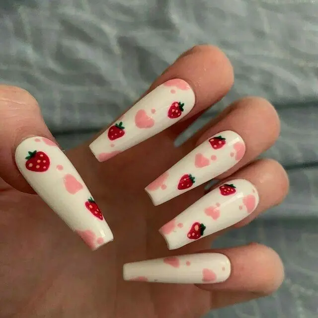 This design features long ballerina-shaped nails with a soft white base and scattered strawberry and pink heart patterns. The playful and romantic theme offers a sweet touch to a classic manicure, suitable for all ages and occasions.