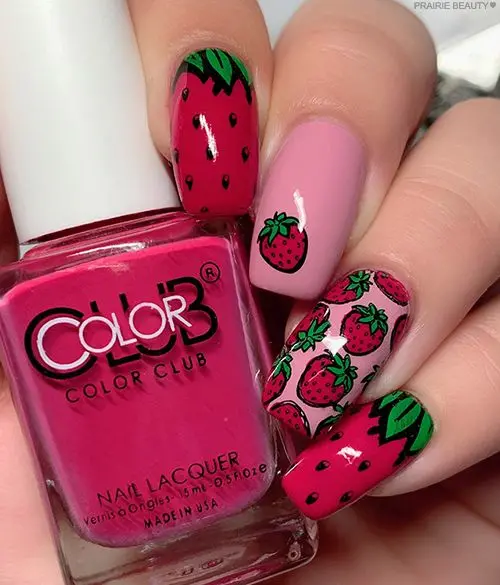 This playful nail design features a mix of vibrant red and pink nails, with intricate strawberry patterns and a glossy finish. Ideal for a bold, fun look that stands out, the design combines solid colors and detailed artistry.