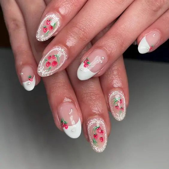 Elegant and intricate, this design on almond nails showcases strawberries encased in delicate white lace patterns on a clear base. The subtle use of white and the detailed artwork provide a sophisticated and refined look suitable for any formal event.