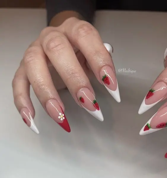 Elegantly long, stiletto-shaped nails with a clean white base and vivid red strawberry designs. This look is perfect for those who love detailed and eye-catching nail art.