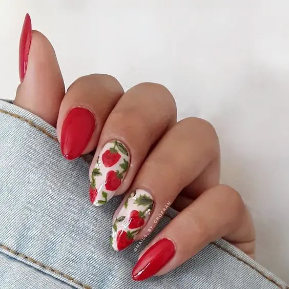 A bold approach with a glossy red finish and intricate strawberry patterns on a white base. This design is tailored for those who love to make a statement with their nail art, suitable for both festive seasons and bold fashion statements.