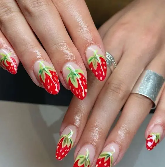 Realistic strawberry patterns dominate this design, with each almond-shaped nail mimicking the fruit\'s texture and seeds on a sheer base. This eye-catching look is perfect for those who want a natural yet dramatic flair on their nails.