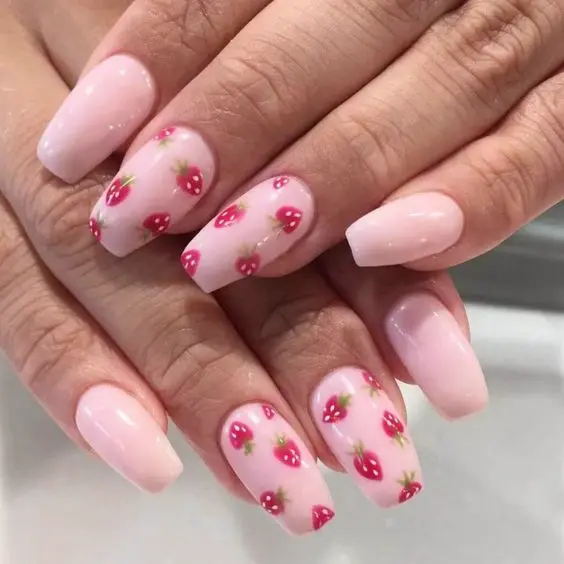 This elegant design features soft pink ballerina-shaped nails with tiny red strawberries delicately placed throughout. The subtle use of color and pattern offers a sophisticated yet cheerful style, ideal for spring or summer days.