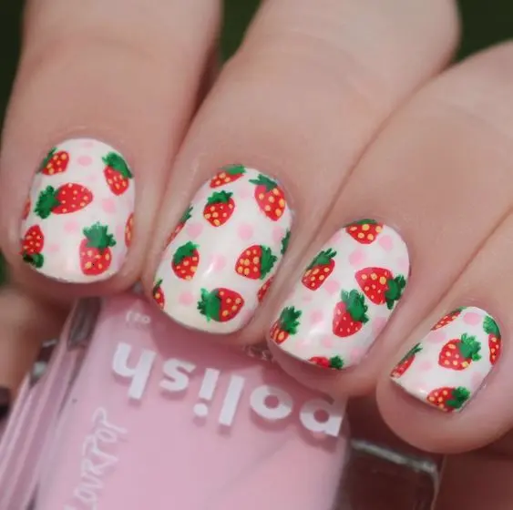 Elegant and understated, this manicure pairs soft pink nails with detailed strawberry and daisy motifs set against a crisp white base. The classic design is perfect for those seeking a subtle yet beautiful nail art style.