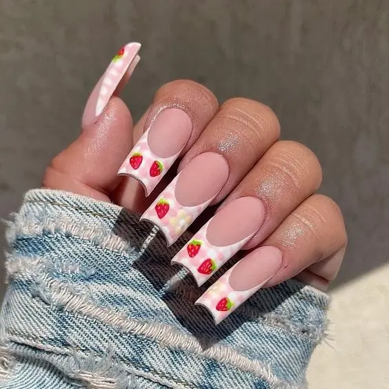 This nail design showcases playful strawberry motifs on a sheer pink base with glossy finish. The nails are shaped into a square form, enhancing the whimsical yet chic look, ideal for adding a touch of fun to any outfit.