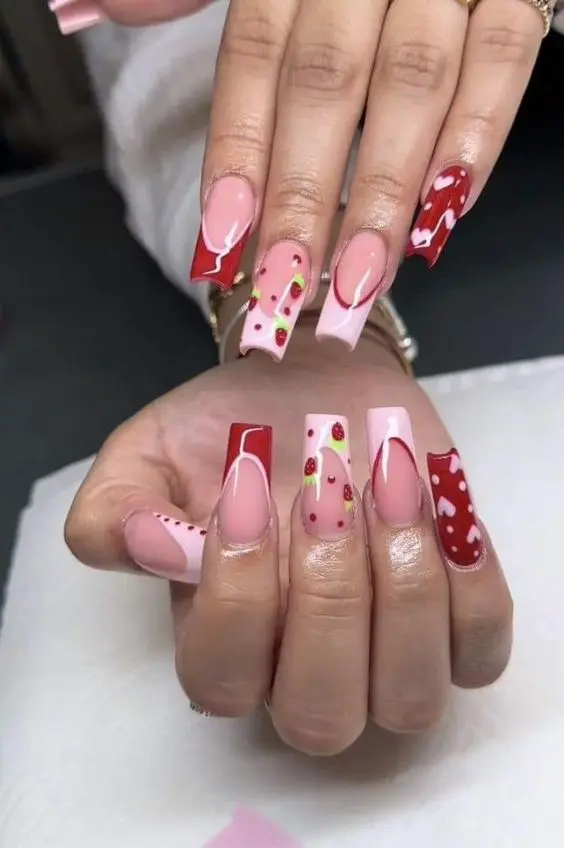 This set of ballerina-shaped nails features alternating designs of solid pink and white bases with red accents and strawberry motifs. It combines elegance with a playful edge, making it a versatile choice for everyday wear or special events.