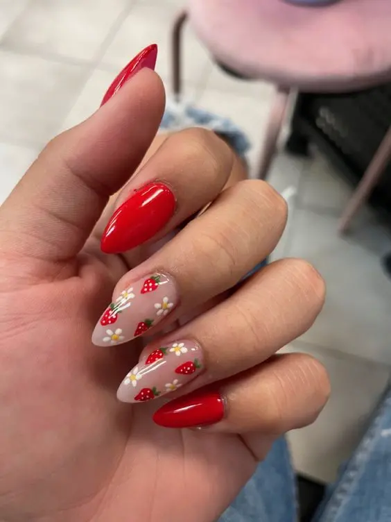 Featuring a bold red and serene white color scheme, these nails are adorned with strawberries and delicate white flowers, presenting a classic yet playful look suitable for any festive occasion or casual wear.