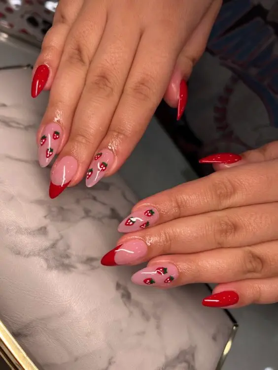 Fresh and minimalist strawberry nail design, perfect for spring and summer. Features soft pink nails with small, detailed strawberry and floral patterns, offering a subtle yet charming look.