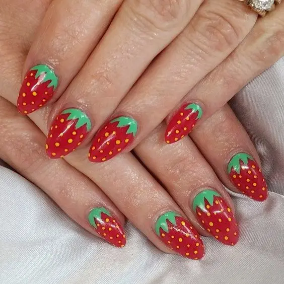 Bold and bright, these nails feature a rich red color with a strawberry design. They\'re perfect for making a statement and adding a touch of whimsy to any outfit.