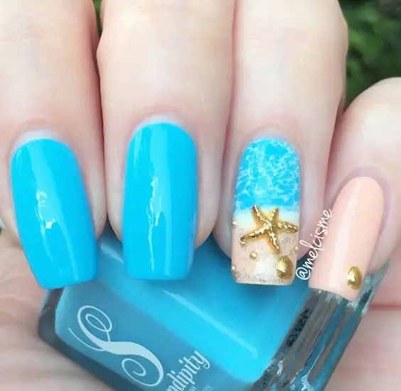 Medium length nails with a solid blue base and one accent nail featuring a beach scene with a starfish. This vibrant design captures the essence of a tropical summer.