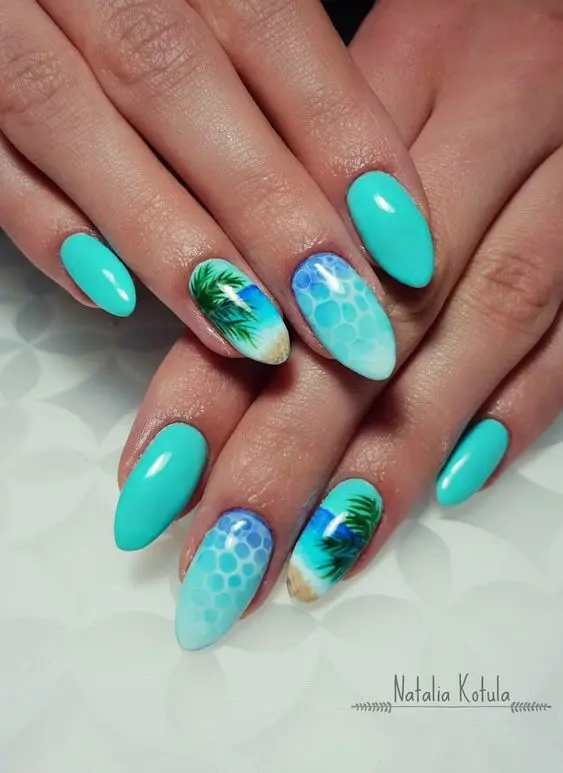 These almond-shaped nails feature a vibrant blue with beach elements like palm trees and sea foam, capturing a fun and tropical summer vibe.