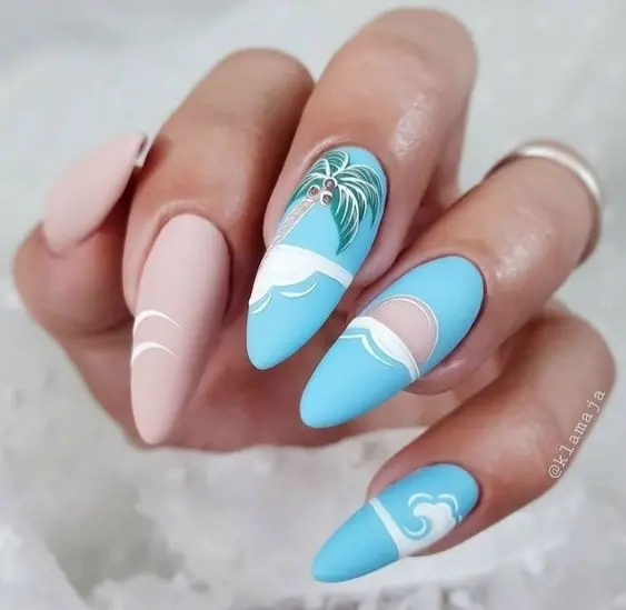 Showcasing stiletto-shaped nails, the design integrates soft pastel pink and blue tones with minimalistic palm tree art. The matte finish and delicate details evoke a serene beach, ideal for summer elegance.