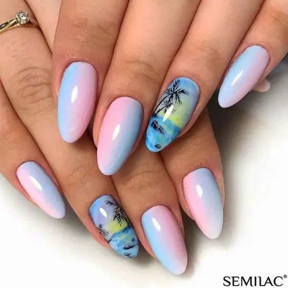 Almond-shaped nails with a gradient of pink and blue, featuring palm trees and beach scenery. The soft pastel tones evoke a serene summer sunset.