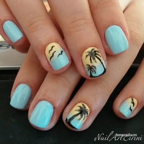 Short squoval-shaped nails with pastel blue and yellow gradients, accented with black palm trees and flying birds, reflecting a serene summer evening.