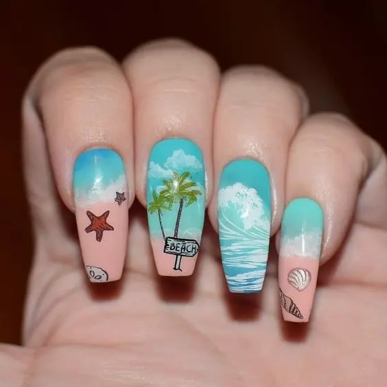 Ballerina-shaped nails with beach scenes, palm trees, and ocean waves in vibrant blue and green hues, representing a tropical summer getaway.