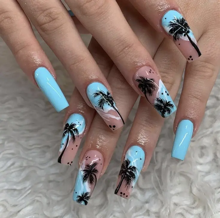 Ballerina-shaped nails with blue and beige colors, featuring black palm tree silhouettes. The design embodies a relaxing tropical summer vibe.