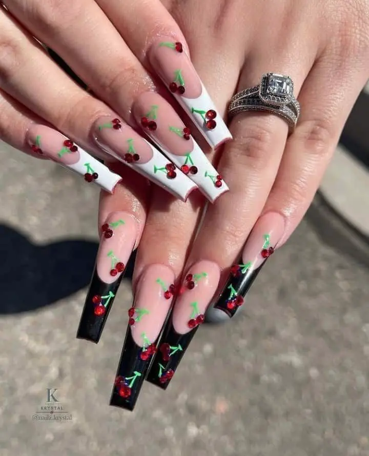 A playful summer twist with cherries on a transparent and black base, these long ballerina nails are as daring as they are delicious-looking.