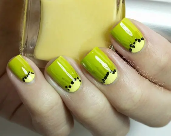 Vibrant green nails with kiwi seed accents, creating a bold and juicy look that’s ripe for the summer season.