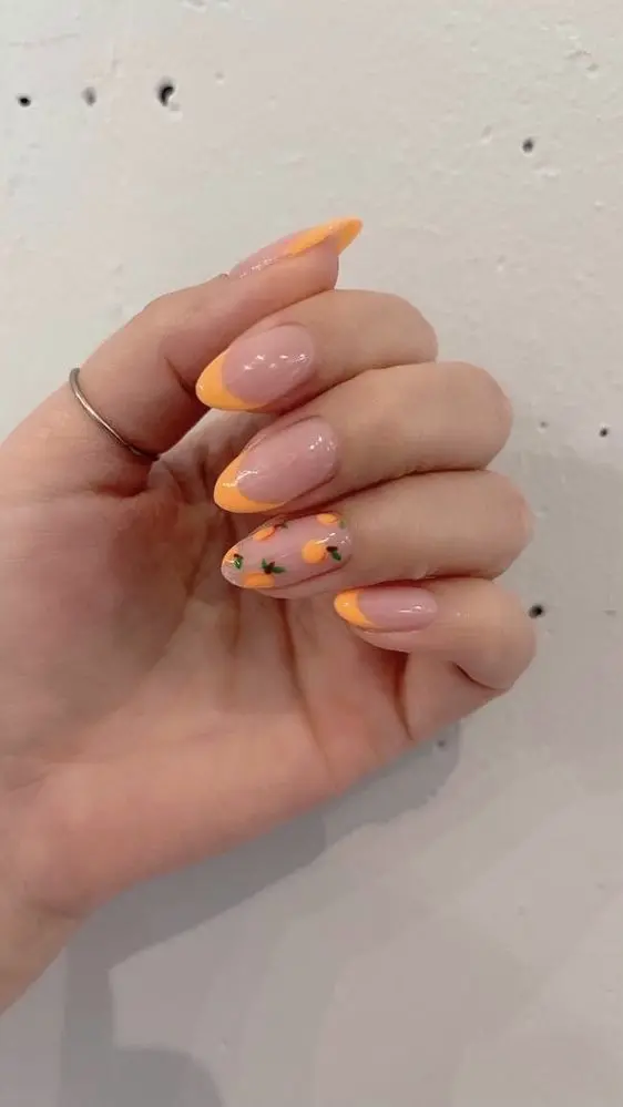 Summer citrus vibes shine through with these almond-shaped nails featuring sunny yellow tips and delicate orange fruit designs, exuding freshness and zest.