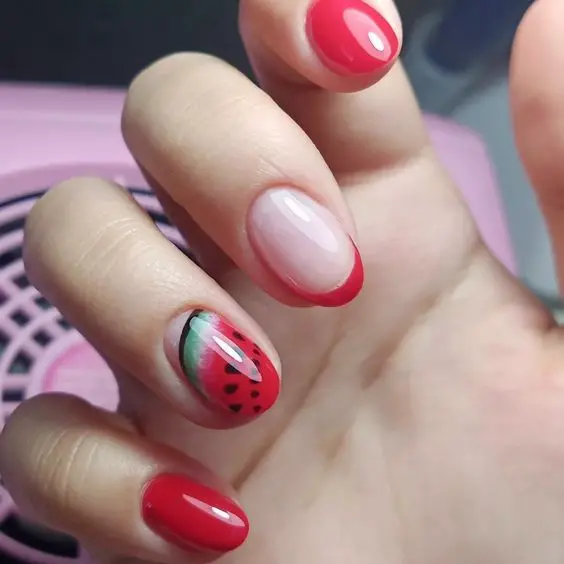 Classic red nails get a playful twist with one accent nail depicting a ripe watermelon slice, adding a dash of summer to a traditional manicure.