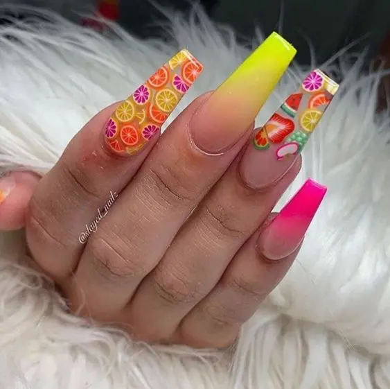 A burst of summer fun, this nail design combines neon shades and fruity patterns for a lively and refreshing look that\'s perfect for sunny days.