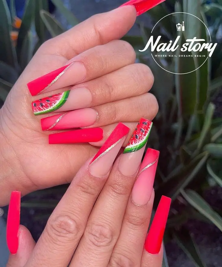 These long, angular nails make a dramatic summer statement with striking red and fresh watermelon designs, perfect for a tropical getaway.