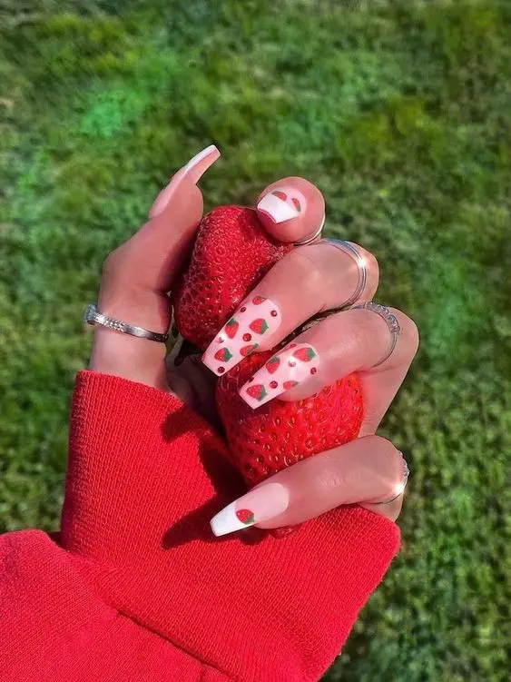 Grabbing summer by the berries, these ballerina nails combine a bold red base with strawberry accents for a look that\'s ripe and ready for sunny adventures.