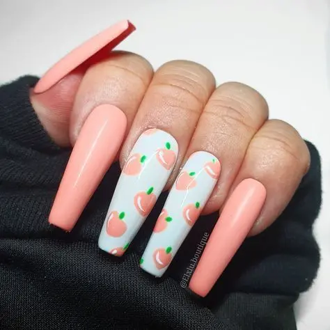 Soft peach nails paired with white and fresh peach fruit designs create a sweet and charming look, reminiscent of warm summer orchards.