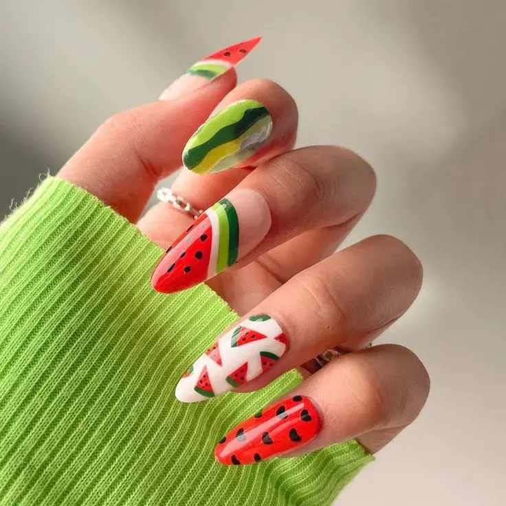 A quirky array of watermelon-inspired designs on variously styled nails, providing a colorful and playful look that screams summer.