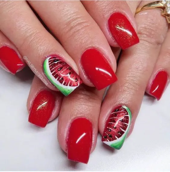 Shimmering red nails with intricate watermelon art on accent nails, capturing the essence of summer with a glossy, square finish.