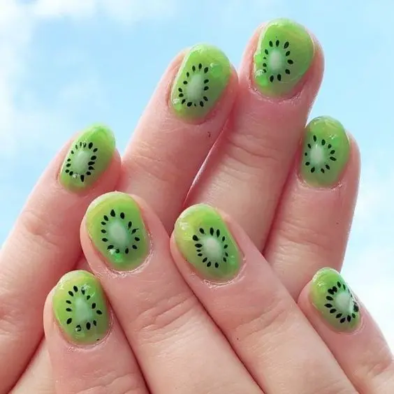 Soft jelly green nails with a kiwi fruit design offer a translucent, refreshing look, ideal for a cool and quirky summer style.