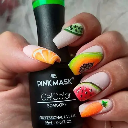 An array of summer fruits like kiwi, orange, and strawberry on a white base makes for a vivid, multi-fruit manicure perfect for the season.