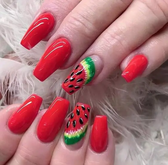 Glossy red nails create a striking backdrop for detailed watermelon designs, making for a vibrant and refreshing statement perfect for summer festivities.