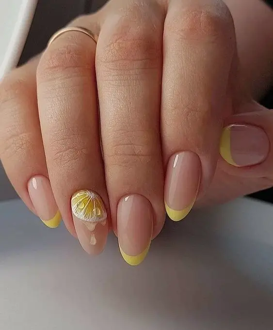 These nails feature a classic French tip style with yellow tips and a clear base. The accent nail showcases a detailed yellow and white flower, adding a touch of elegance and freshness to this chic summer look.