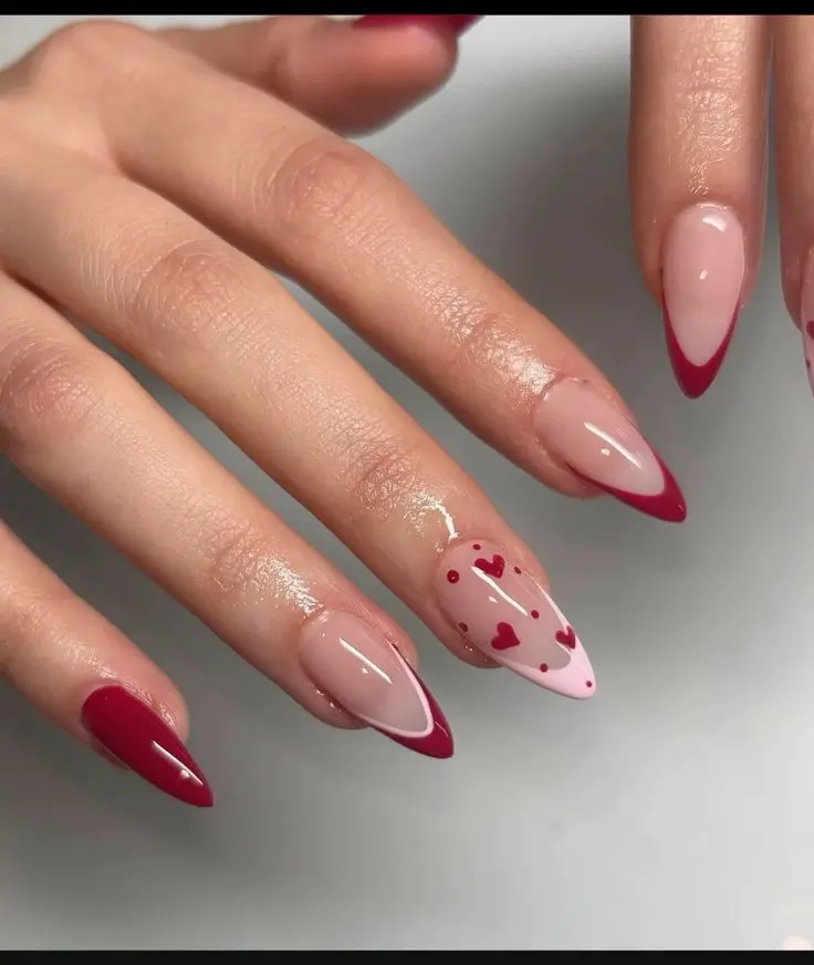 Featuring stiletto-shaped nails, this design blends nude and red tones with playful heart patterns. The mix of solid red nails and heart-decorated nails creates a lively and charming look, ideal for those who want to express their fun and loving side.