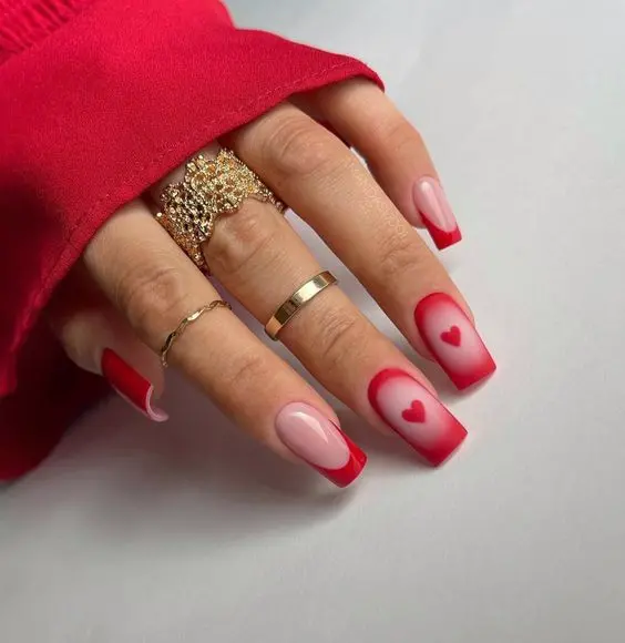 These nails present a gradient effect from red to pink with heart accents. The soft transition and heart details provide a romantic and elegant appearance, perfect for expressing love and affection.