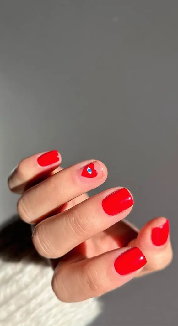 This nail art features a mix of solid red nails and nude nails with red heart outlines. The matte finish and squoval shape provide a chic and modern look, perfect for showcasing love and affection in a stylish way.