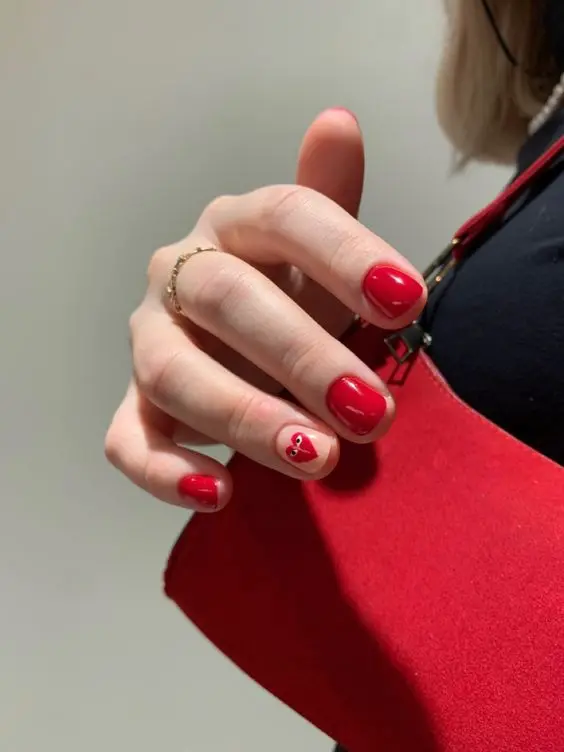 These nails combine solid red and white polishes with heart accents, creating a playful and eye-catching design. The squoval shape and glossy finish add a touch of elegance, making it suitable for any romantic celebration.