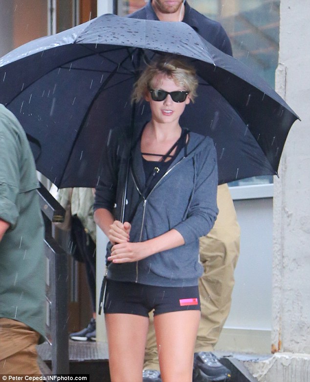 Rainy day: After working out, the 10-time Grammy winner emerged from the building shielding herself from the New York rain with a trusty umbrella