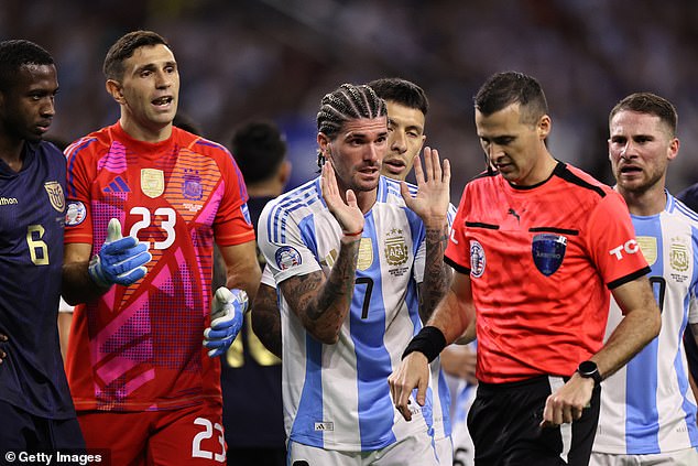 Rodrigo De Paul (7) raises his hands pleading innocence after giving away a penalty