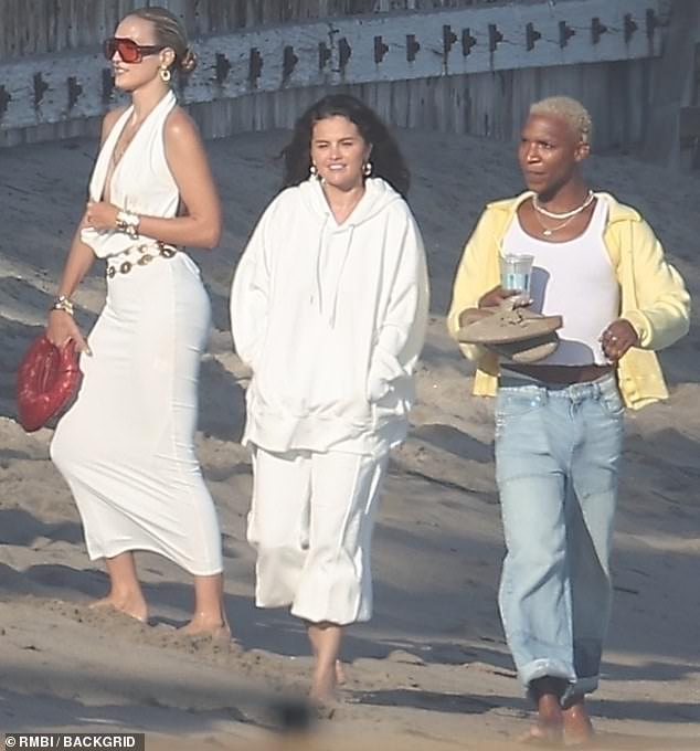 She was also surrounded by friends, with whom she was spotted enjoying a stroll on the beach amid the sweltering California summer