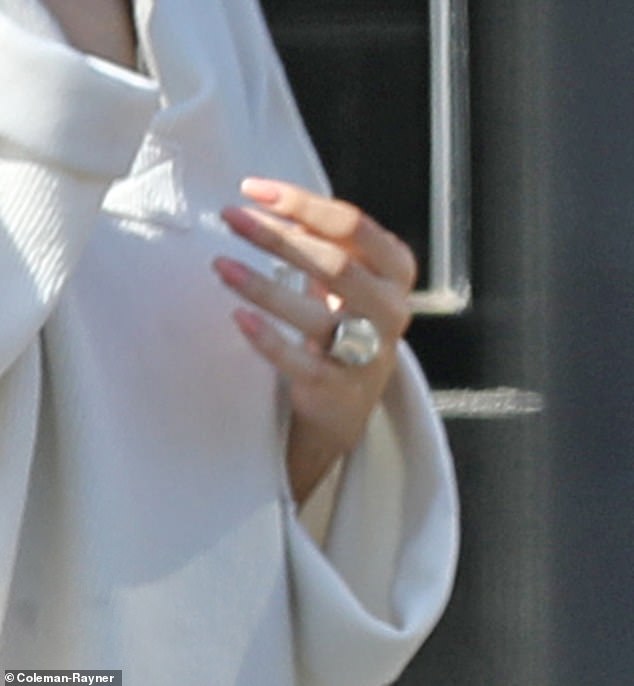 New bling: The beauty kept her accessories to her new sparkler on her ring finger